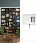 Side view of a clear Large Thermostat Guard with keyed lock, fits most thermostats up to 8.25x5.75 inches, shown in living room.