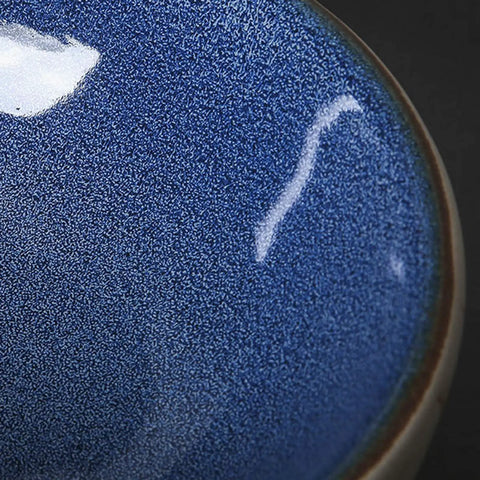 Close-up of Hella Sleek Round Porcelain Bathroom Vessel Sink With Chrome Pop Up Drain, glossy blue finish.