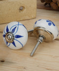 Top Shelf 10 Pack Ceramic Cabinet Knobs With Blue And White Printed Antique Patterns Sweet Glossy Finish Drawer Pull Handles For Kitchen Cupboards And Wardrobes. Close-up of two ceramic knobs with blue patterns.