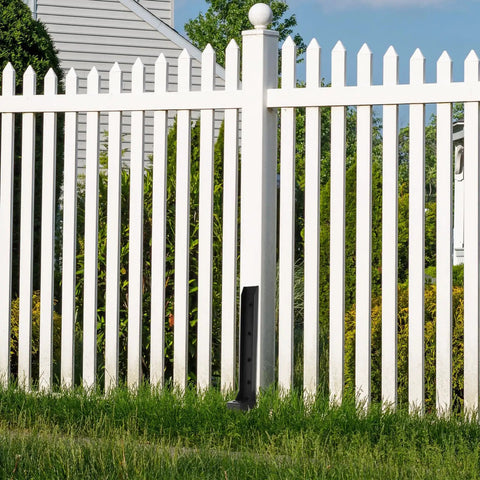 Installed Two Pack Heavy Duty Metal Fence Post Repair Kit With Ground Spike Anchors for tilted or broken posts in a white picket fence