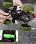 Hands inserting battery into Awesome All Terrain Dinosaur RC Car For Kids With 2.4Ghz Remote Control Light Up 4WD Monster Truck