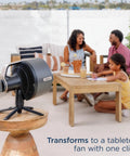 FlexBreeze Pro Mist Fan Indoor Outdoor Chill Machine on tabletop with family in the background enjoying outdoor space.