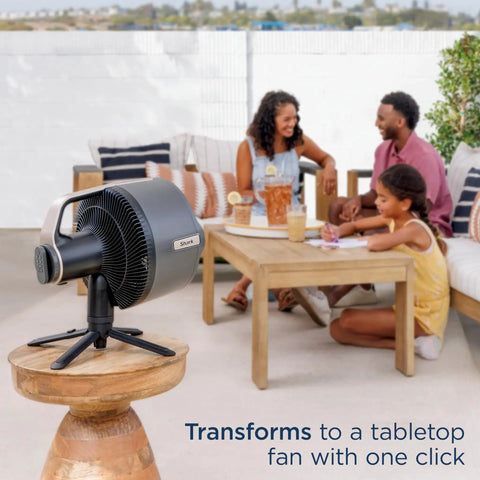 FlexBreeze Pro Mist Fan Indoor Outdoor Chill Machine on tabletop with family in the background enjoying outdoor space.