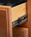 Side view of a 20 Inch Double Spring Soft Close Drawer Slide installed in a wooden kitchen cabinet, showing ball bearing detail.