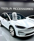 Badass Heavy Duty Weatherproof Car Cover For Tesla Model X Silver Microfiber Weave covering SUV hood in showroom.