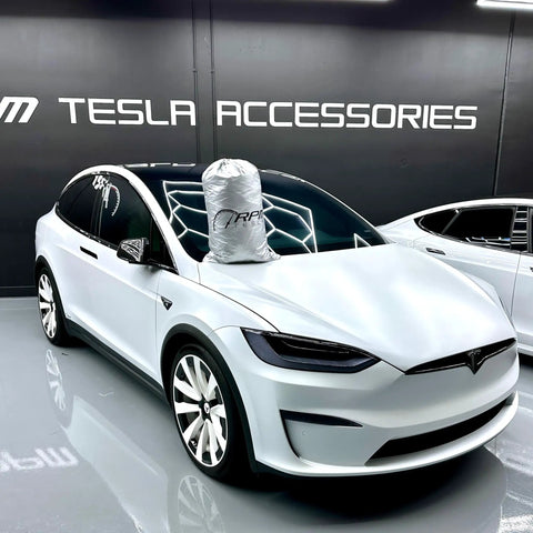 Badass Heavy Duty Weatherproof Car Cover For Tesla Model X Silver Microfiber Weave covering SUV hood in showroom.