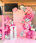 Colorful display of Pink Cow Print Balloons Party Kit 67 Piece Set For Birthday Baby Shower Rodeo Farm Party Decorations Includes 12 Inch Cowgirl Balloons In Hot Pink Pink Light Pink Cow Print Confetti Balloons And Pink Ribbon.