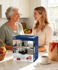 Two women talking in a kitchen with a boxed Powerful 1200W Immersion Hand Blender With 5 In 1 Attachments on the counter.