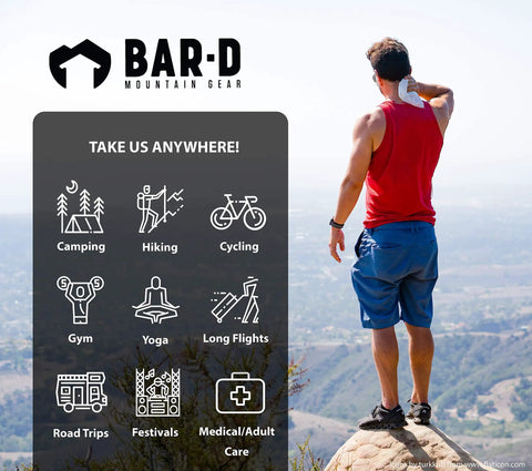 Man using biodegradable body wipes with tea tree oil and aloe vera on mountain, ideal for hiking and post-workout