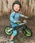 Child riding bike wearing Kid Friendly Knee And Elbow Pad Set With Pro Grade Bike Gloves For Ages 2-11 Dinosaur Design