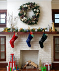 Christmas fireplace with stockings, wreath, and gifts, decorated for the holiday season.