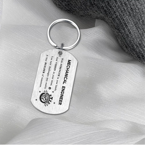 Gearhead Mechanical Engineer Gift Keychain For Students And Pros - Inspirational Engineering Charm For Graduation, Christmas, Or Birthday - Perfect Gift For Men And Women In STEM. Displayed on fabric, brushed stainless steel.