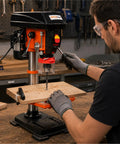 12-Inch Benchtop Drill Press With Integrated Laser Guide For Dead-On Accuracy On Wood And Metal Projects Featuring Five Variable Speeds From 450 To 3150 Rpm For Versatile Shop Performance in use at a workbench.