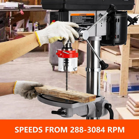 User operating the 13 Inch Floor Drill Press With 7.5A Motor, Heavy Duty Cast Iron Construction For Wood And Metal Work, drilling wood.