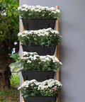 Stacked Four Pack Window Box Planters With Easy Install Adjustable Brackets, black, filled with flowers, for balcony and patio decor.