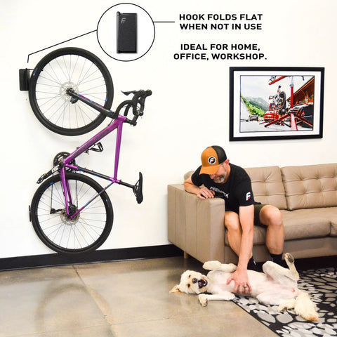 Velo Hinge Two Point Zero Pivoting Bike Wall Mount Single Vertical Bicycle Hanger mounted in living room showing fold away design.