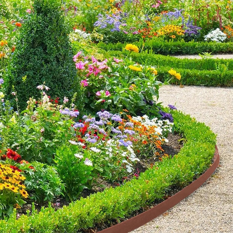 33Ft Landscape Edging Kit With Four Inch High Paver Border Edging And 30 Stakes Included in a colorful garden setting, black border