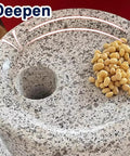 No Fuss Manual Stone Grain Mill with hand crank showing natural granite texture and hole for dry and wet grinding, yellow beans on top.