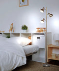 Ethan Dimmable Floor Lamp For Bedroom Reading And Living Room Decor, nickel finish, featuring LED heads, near a bed.