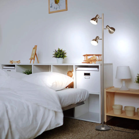Ethan Dimmable Floor Lamp For Bedroom Reading And Living Room Decor, nickel finish, featuring LED heads, near a bed.