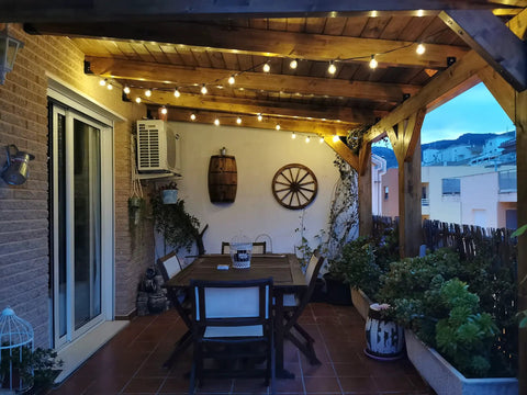 Cozy patio with two pack 100 foot outdoor string lights with dimmable G40 LED bulbs that are shatterproof and weatherproof.