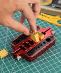 Slick Aluminum Soldering Insulation Station Jig For RC Battery Connectors XT60 XT90 And Banana Plugs, person using jig for soldering.