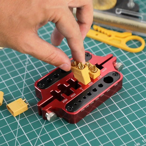 Slick Aluminum Soldering Insulation Station Jig For RC Battery Connectors XT60 XT90 And Banana Plugs, person using jig for soldering.