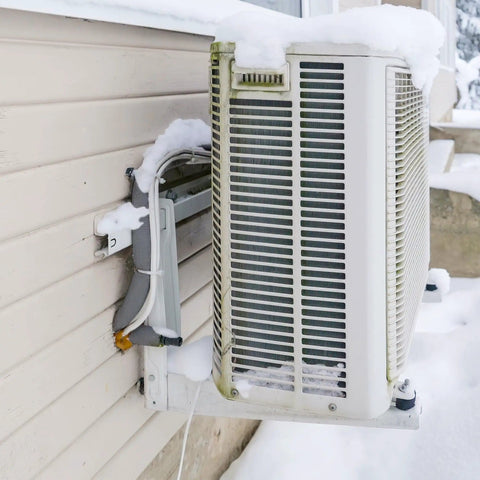 Outdoor AC unit with snow, showcasing use for Five Pack Three Quarters Inch ID Foam Pipe Insulation Tubes Sixteen Point Nine Inch Length Grey