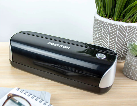 Workhorse Electric 3-Hole Punch for office use, shown on a desk with a black finish, AC or battery powered