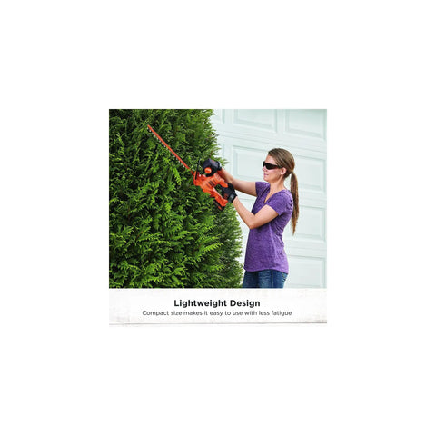 Person using 20V Max Cordless Hedge Trimmer With 18 Inch Dual Action Blade Delivers Up To 2400 Cuts Per Minute Handles Branches Up To Five Eighths Inch Includes Battery And Charger Lightweight With Reduced Vibration LHT218C1 on shrubs.