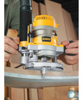 Person using Adjustable Plunge Router Base For DW616 And DW618 Routers With Tool Free Steel Cam Lock on wood edge