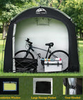All Weather Outdoor Bike Storage Shed Tent Waterproof Portable Bicycle Cover With Thirty Percent More Top Storage Space For Two To Five Bikes No Hassle Setup Shelter For Motorcycle Garden Tools And Lawn Mower in a garden.