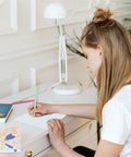 Woman writing on a Six Pack Sailing Greeting Card Featuring Gulet Sailboat Acrylic Art Blank Inside For Your Message