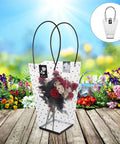Plastic Bouquet Bags With Handles For Flower Packaging in a garden setting, holding roses, with handle for easy carrying.