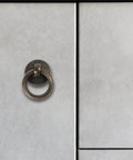 Close-up of Vintage Style Ring Pull Cabinet Handle in antique bronze on a white cabinet, single-hole, durable alloy.