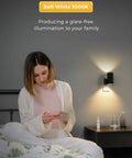 Woman reading in bed with Four Pack Plug In Night Lights With Dimmable Brightness, Light Sensor Auto On Off, Soft White 3000K Black Shade