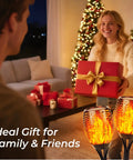 Woman holding gift beside Six Pack Solar Torch Lights With Realistic Flickering Flame, 96 LED Outdoor Pathway Torches