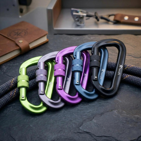 Beefy 12kN Heavy Duty Carabiner Clips With Ultralight Screw Lock Locking Design in assorted colors on a stone surface
