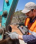 Worker using Heavy Duty Pneumatic Grease Gun Workhorse With 6000 PSI High Pressure Air And 18 Inch Hose for machinery lubrication.