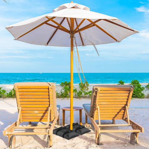Beach umbrella setup with 90 Lb Extra Large Umbrella Base Weight Set Of Two For Patio Fillable Sand Bags; chairs nearby.