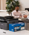 Compact Monochrome 3 In 1 Laser Printer With Copy Scan And Auto Duplex Wireless And Mobile Printing Alexa Compatible No Fuss Small Biz Workhorse For Home Office Use Includes Refresh Trial displayed on a desk