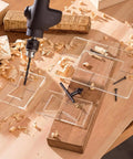Pro Tier 3 Pack Bow Tie Inlay Router Template Kit With Slick Acrylic Guides on wood with drill and wood shavings