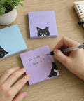 Black Cat 3x3 Sticky Notes Set Self Stick Memo Pads with cat design on desk, handwritten message on purple pad