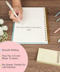 Pack Of Six Smooth Writing Retractable Gel Pens Featuring Snappy Click Mechanism And Fast Drying Black Ink That Rolls Dead Smooth Across Pages Ideal For Classroom Assignments Desk Organization And Daily Note Taking Without Any Smudging, shown in use on a lined notebook.