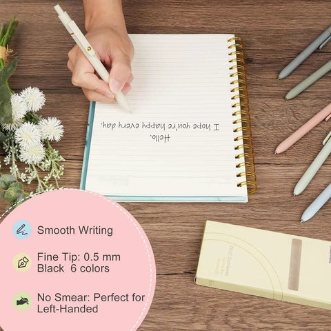 Pack Of Six Smooth Writing Retractable Gel Pens Featuring Snappy Click Mechanism And Fast Drying Black Ink That Rolls Dead Smooth Across Pages Ideal For Classroom Assignments Desk Organization And Daily Note Taking Without Any Smudging, shown in use on a lined notebook.