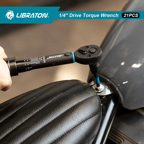 Using Bike Torque Wrench One Quarter Inch Drive Five To Twenty Five Newton Meters Micro Click Set on motorcycle seat.