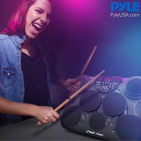 Compact Electronic Digital Drum Kit With Eight Responsive Pads And Kick Pedal Dropping Six Hundred Top Shelf Sounds Usb Midi Integration And Silent Headphone Mode For Night Owl Beat Makers played by a musician.