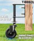 Side view of 4 Inch Spring Loaded Gate Caster Wheel With Side Brake Heavy Duty Gate Wheel For Outdoor Fence Anti Sag 360 Degree Swivel 220 Lb Capacity Black 1 Pack, attached to a wooden gate with a green grass background.