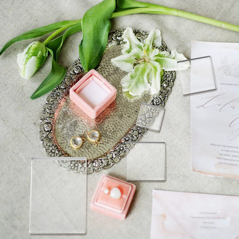 Set Of Six Clear Acrylic Styling Blocks And Flat Lay Props Ideal For Wedding Centerpieces And Product Shoots arranged with jewelry and flowers.