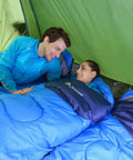 Couple in blue 4 Season Sleeping Bag With Pillow For Camping And Backpacking, Lightweight And Cozy Yet Warm, in green tent